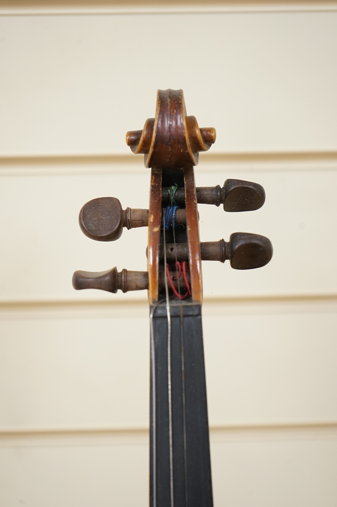 Five cased 20th century violins, including; a German violin, two Czech violins, a three-quarter size violin with a label for Bienfait, and a Romanian quarter size violin, all in cases or the remains of cases.